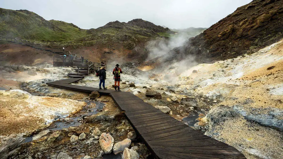 Boardwalk over a bubbling hot spring visited on a Fagradalsfjall volcano tour taking in Grindavik and the youngest lava fields, Iceland