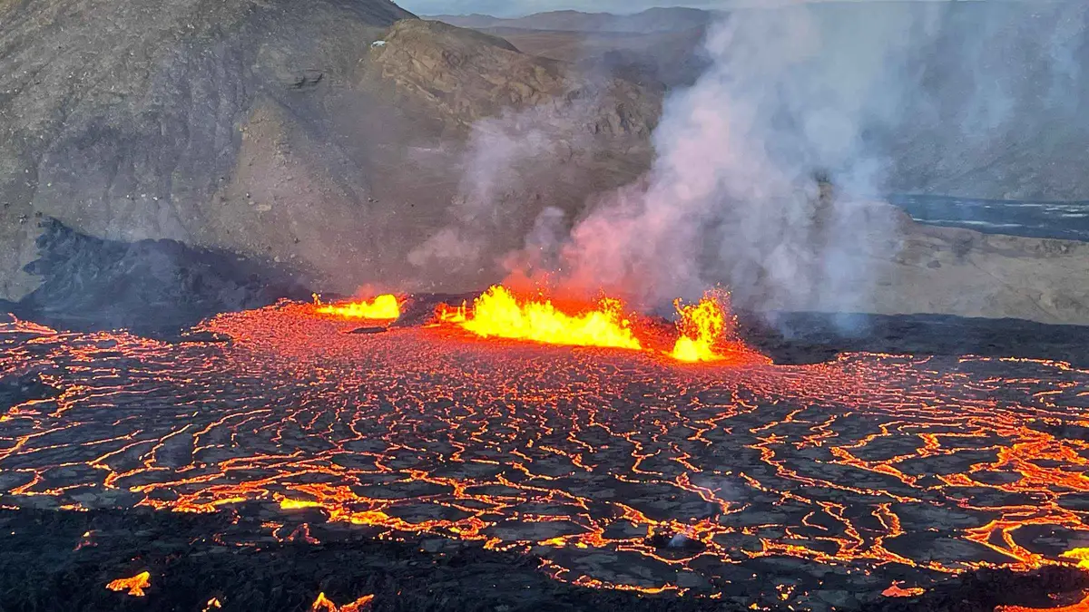 A guide and two travellers alone on the eruption site during a private Fagradalsfjall volcano tour on the Reykjanes Peninsula, Iceland